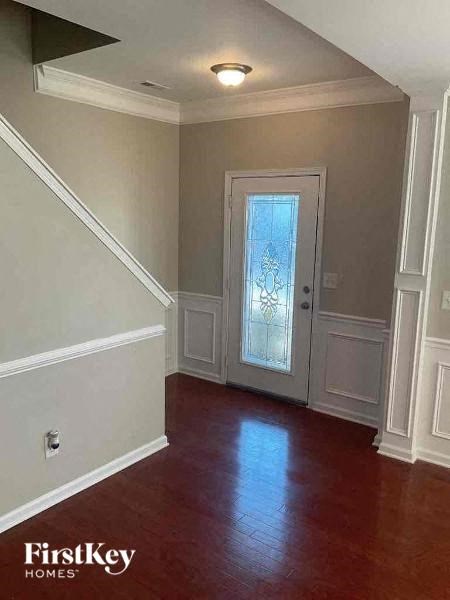 a empty room with a door and a wood floor