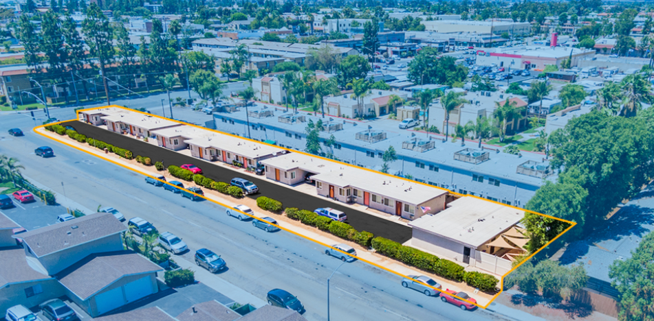 an aerial view of a building with a yellow line around it on a city street