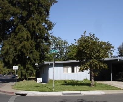 A house with a white sign in front of it.