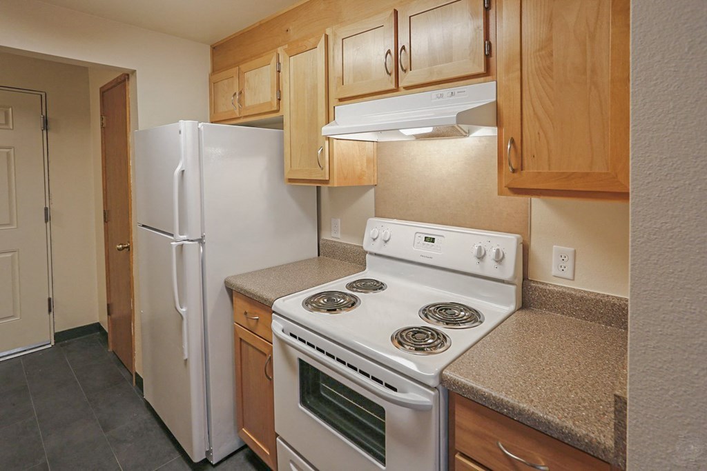 a kitchen with a stove and a refrigerator