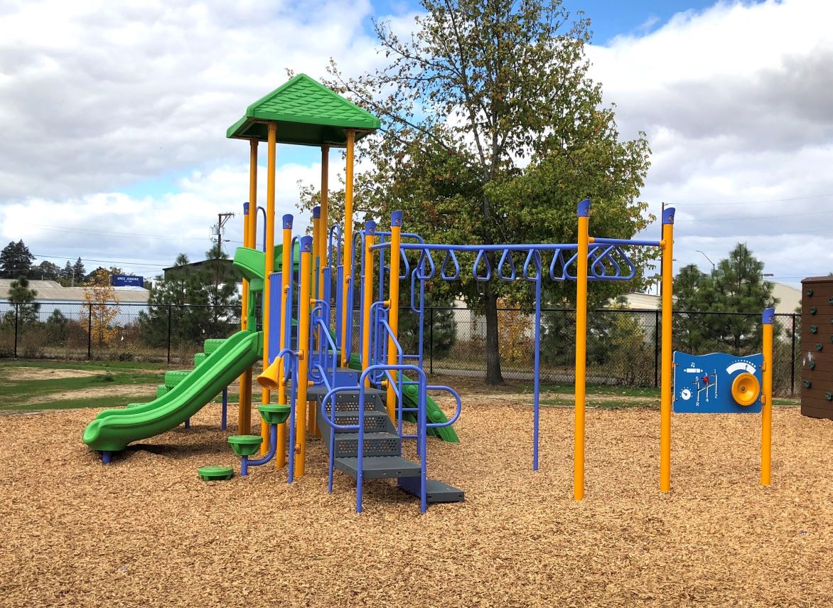 a playground at a park with a swing set