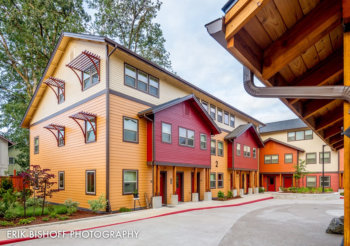 a row of colorful buildings with a street in front of them