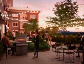 a patio with tables and chairs and a grill at dusk