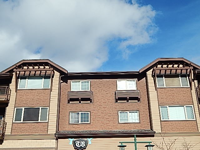a brick building with windows and a blue sky