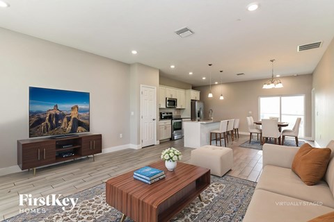 A living room with a wooden coffee table and a large painting on the wall.