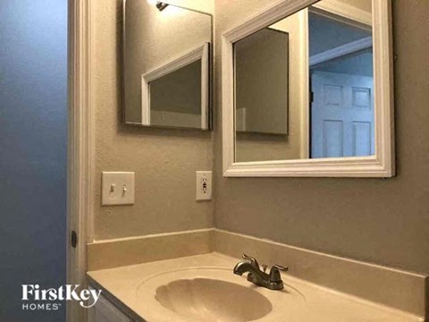 A bathroom sink with a mirror above it.