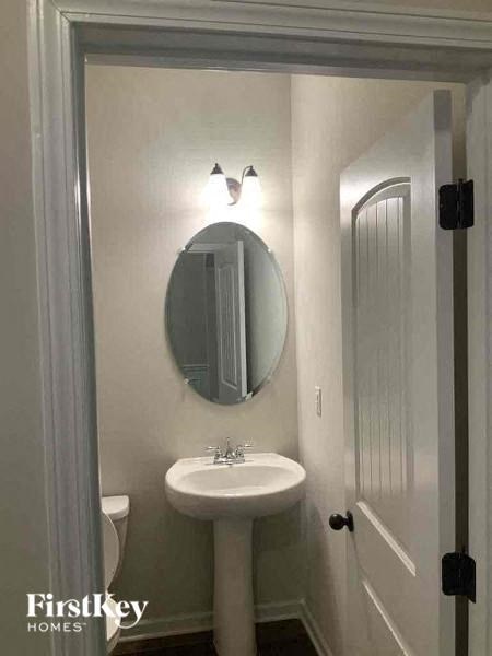 a bathroom with a white sink and a mirror