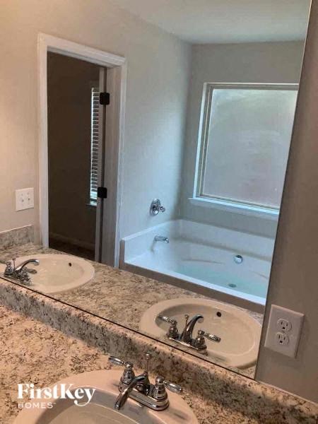 a bathroom with two sinks and a large mirror
