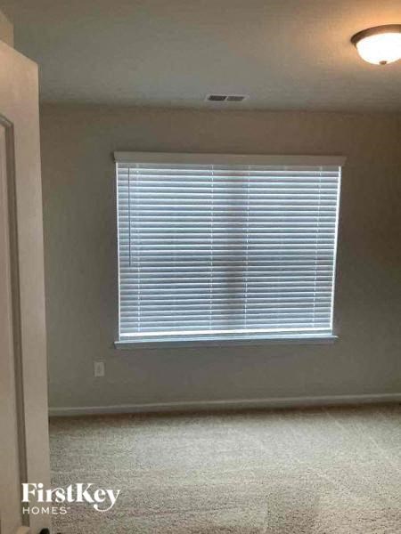 a living room with a window and a light