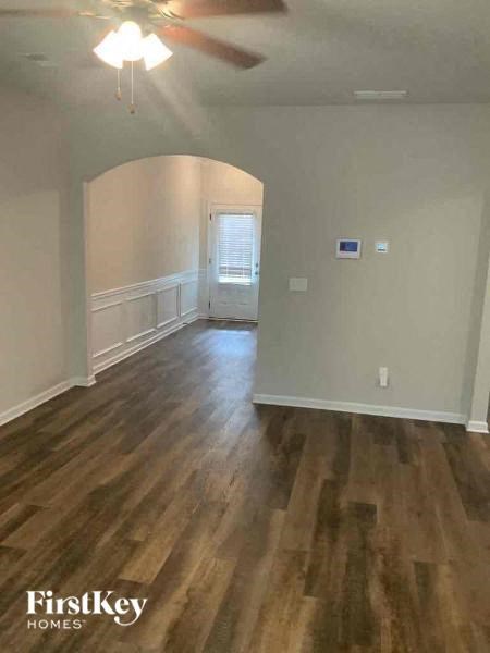 an empty living room with a hard wood floor