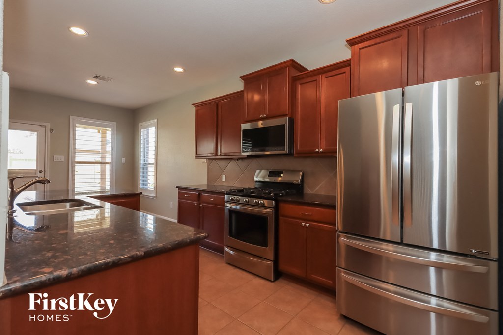 a kitchen with stainless steel appliances and granite counter tops