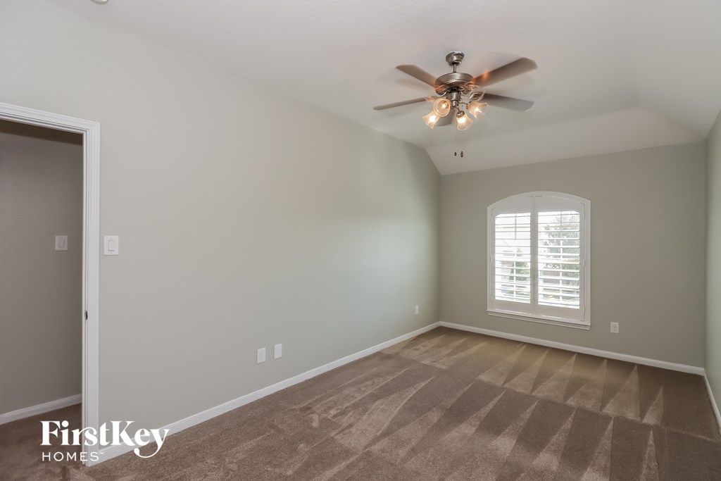 a living room with a ceiling fan and a window