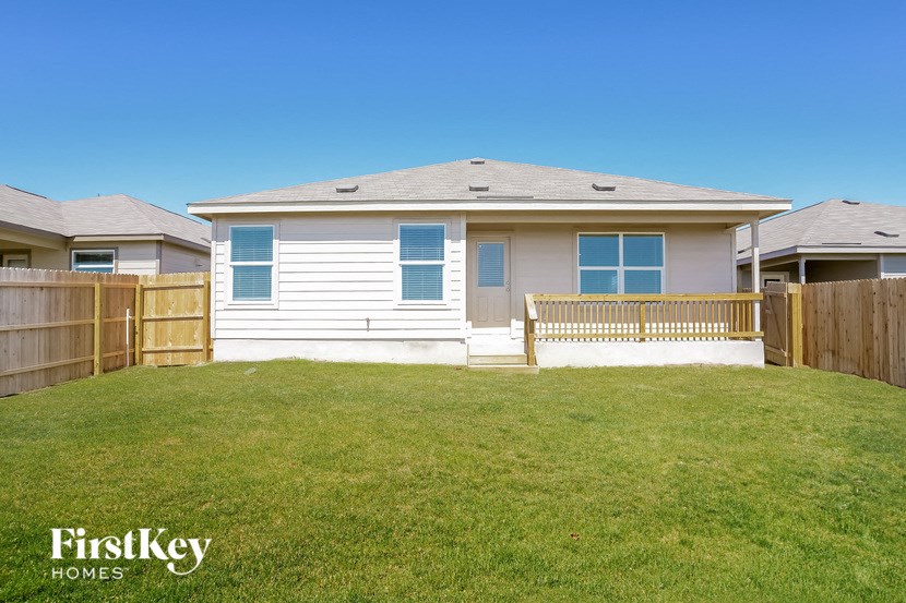 A house with a white exterior and a brown fence.