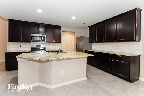 a kitchen with black cabinets and a counter top