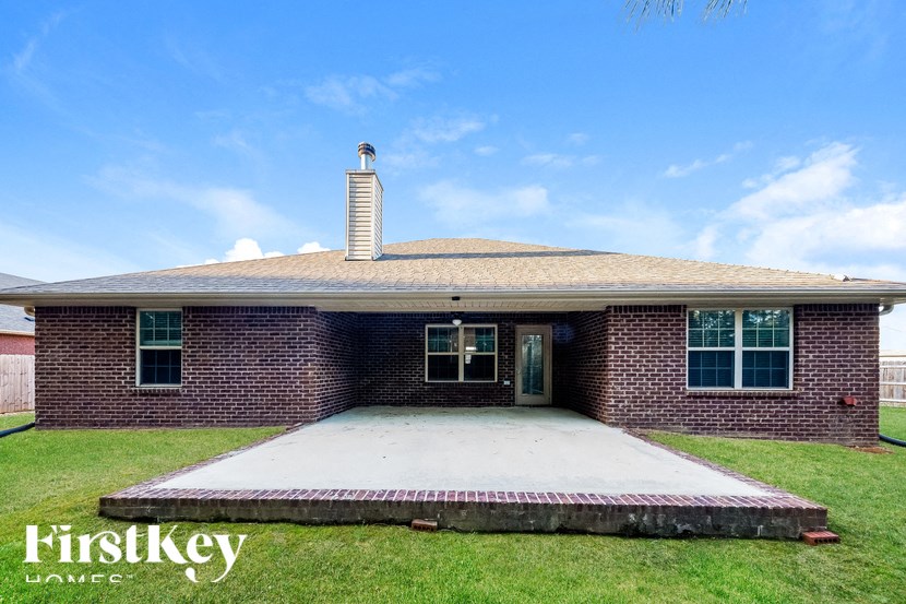 A brick house with a chimney and a porch.