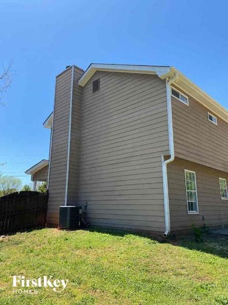 the side of a house with a grassy yard