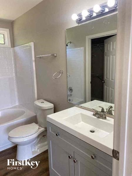 a white bathroom with a sink and a toilet