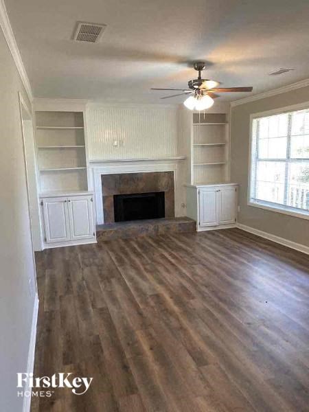 a living room with a fireplace and wooden floors