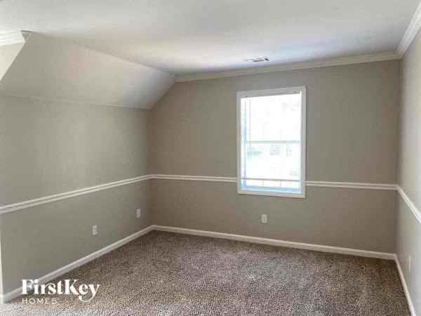 a empty room with a window and a carpet