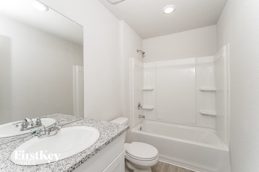 a bathroom with a sink and a tub and a toilet