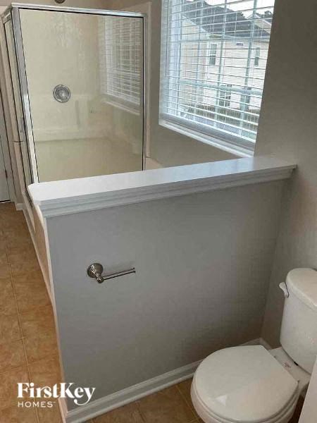 a small bathroom with a toilet and a shower