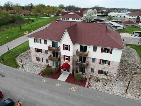 an aerial view of a white house with a red garage door