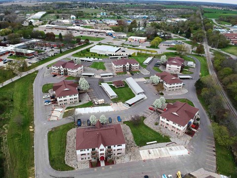 an aerial view of a village with houses and a road