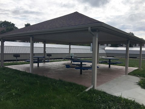 a pavilion with benches and picnic tables