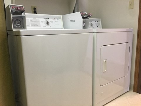 a white refrigerator with some appliances on top of it