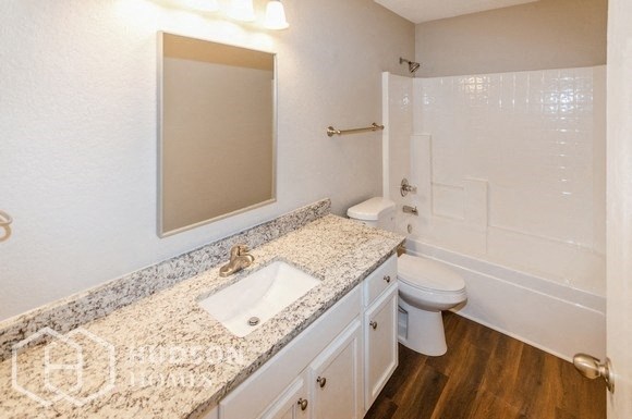 a bathroom with a sink and a toilet and a mirror