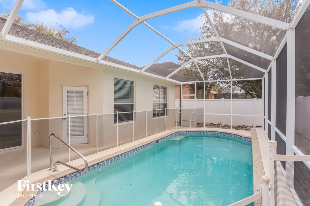 a swimming pool in a house with a screened in pool