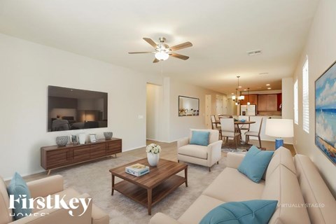 A living room with a brown coffee table and a white couch.