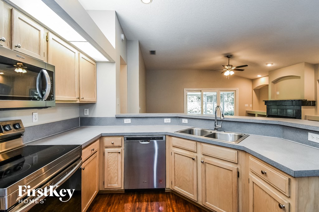 a kitchen with wooden cabinets and stainless steel appliances