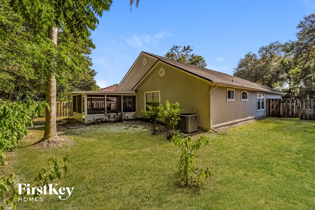 a backyard with a house and a yard and a tree