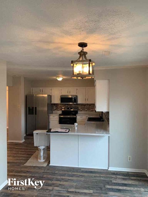 a kitchen with white cabinets and a white counter top