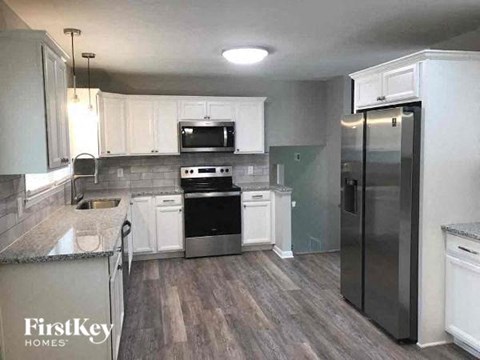 a kitchen with stainless steel appliances and white cabinets