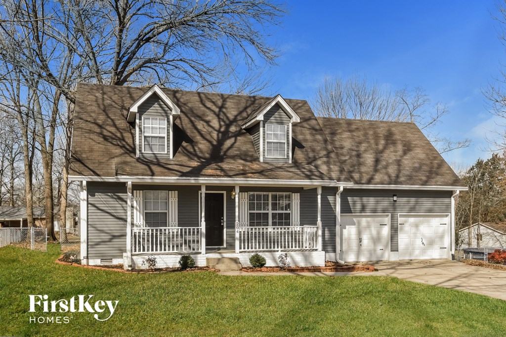 A house with a grey roof and a white garage door.