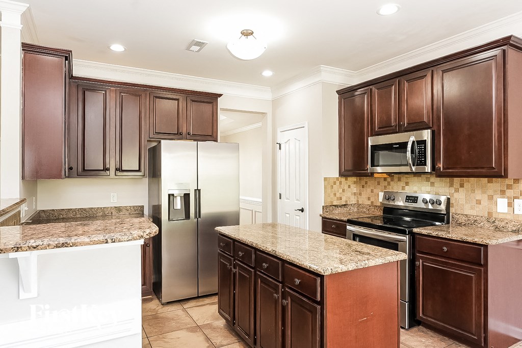 a kitchen with stainless steel appliances and granite counters