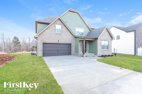 A house with a garage and a driveway is for sale.