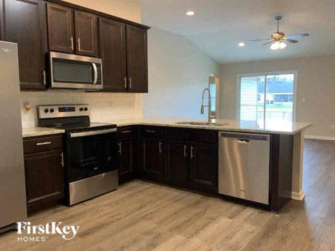 a kitchen with stainless steel appliances and wooden cabinets