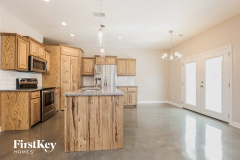 a large kitchen with wooden cabinets and stainless steel appliances