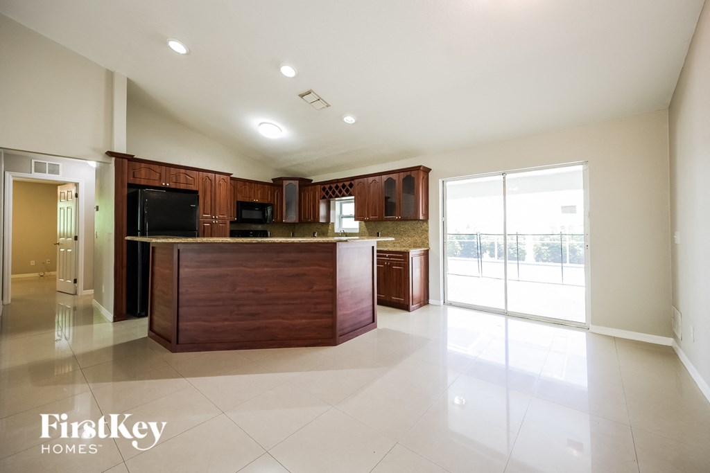 a large kitchen with a large island and a glass door