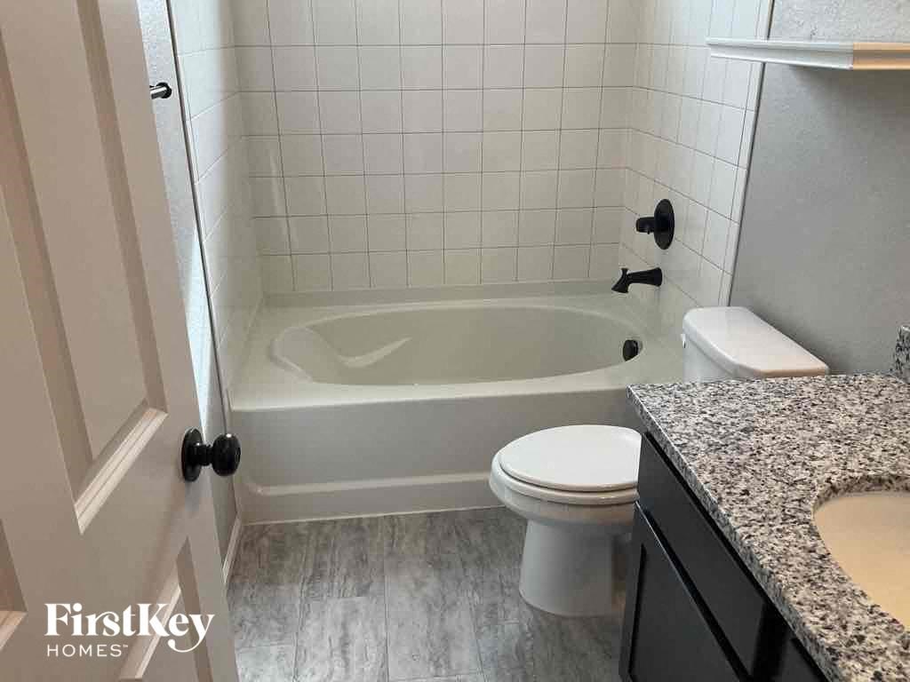 a bathroom with a tub and a toilet and a sink