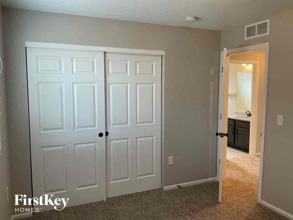 a bedroom with two closets and a door to a bathroom