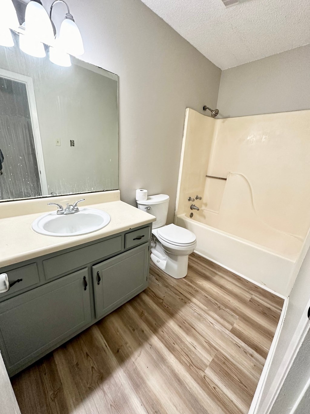 an empty bathroom with a sink toilet and shower