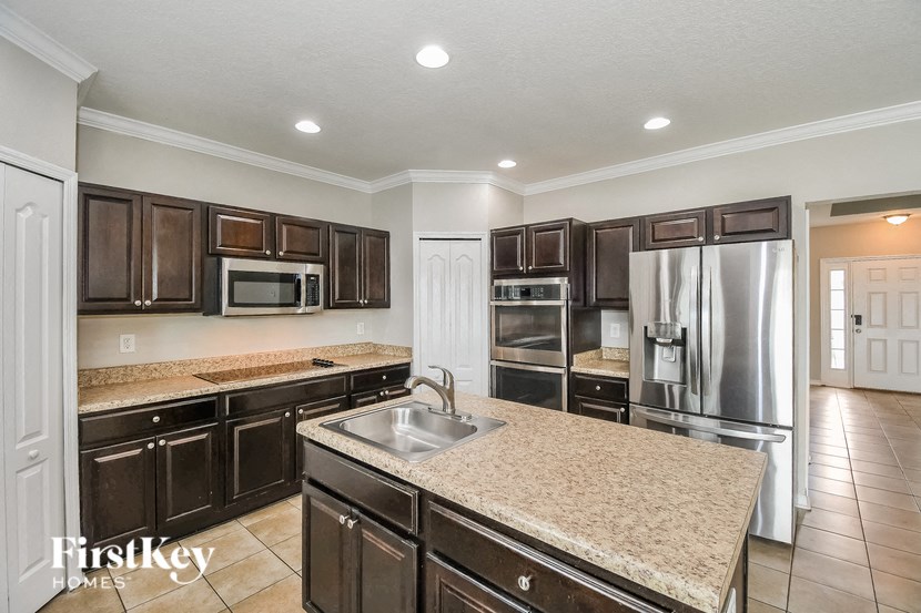 a kitchen with granite counter tops and stainless steel appliances