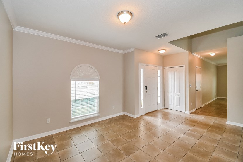 the living room and entryway of an empty house