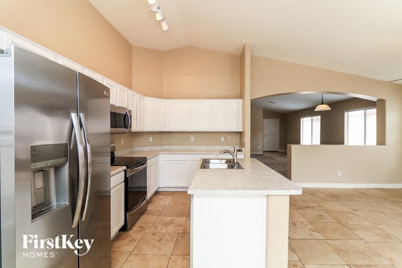 A kitchen with a refrigerator and a counter top.