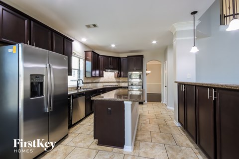 A kitchen with a refrigerator and a countertop.