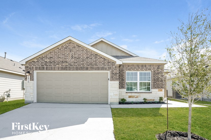 a white and brick house with a garage door